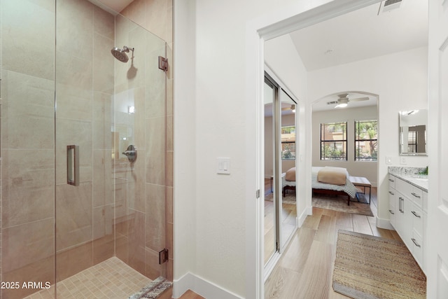 11500 E Cochise Dr Unit 1015, Scottsdale, AZ 85259 - ensuite bathroom with connected bathroom, a ceiling fan, vanity, and a stall shower