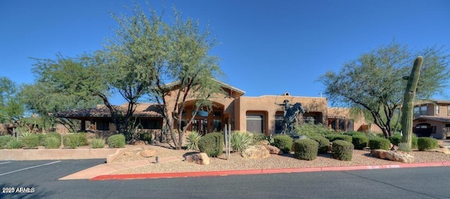 11500 E Cochise Dr Unit 1015, Scottsdale, AZ 85259 - pueblo-style home featuring uncovered parking and stucco siding