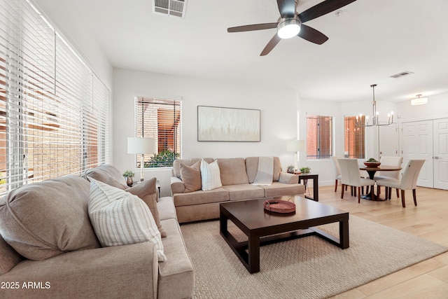 11500 E Cochise Dr Unit 1015, Scottsdale, AZ 85259 - living room featuring visible vents, ceiling fan with notable chandelier, and light wood-type flooring