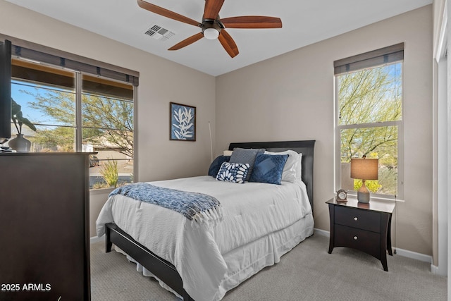 bedroom featuring light colored carpet and ceiling fan