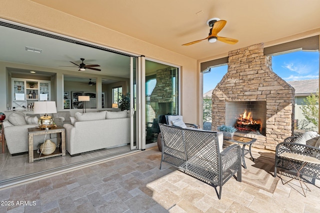 view of patio / terrace featuring an outdoor living space with a fireplace