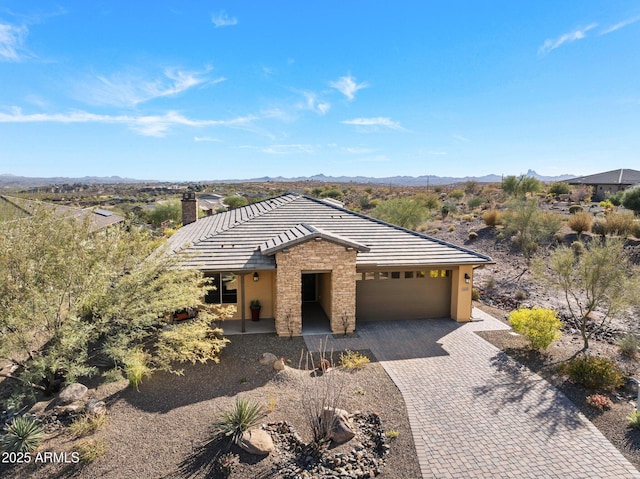 view of front facade featuring a mountain view and a garage