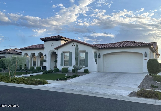 mediterranean / spanish home featuring a garage