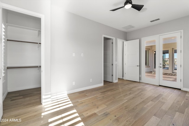 unfurnished bedroom featuring light wood-type flooring, french doors, and ceiling fan