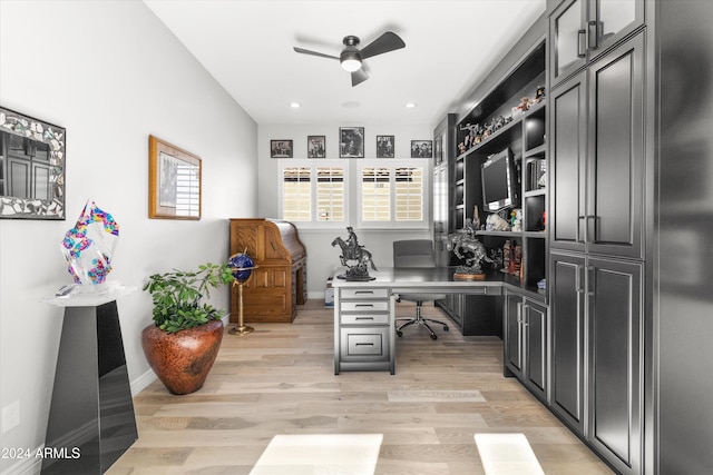 office with light hardwood / wood-style flooring and ceiling fan