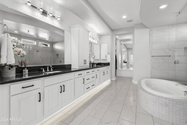 bathroom featuring vanity and separate shower and tub