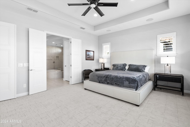 bedroom with ensuite bath and ceiling fan