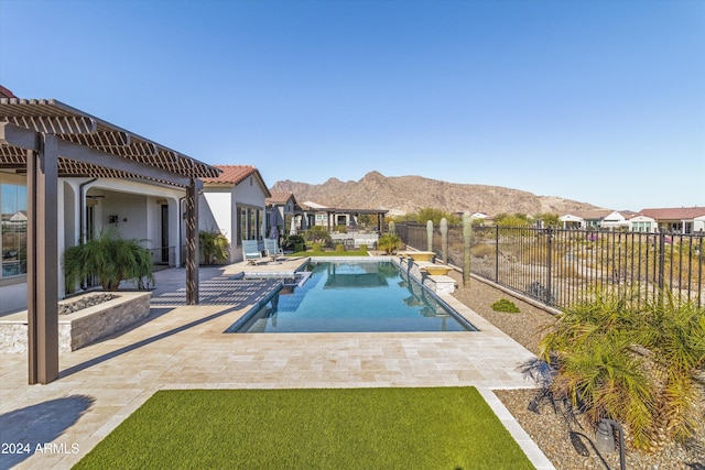 view of pool with a mountain view and a patio