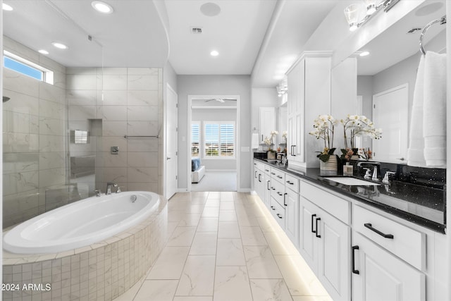 bathroom with vanity, plus walk in shower, and a wealth of natural light