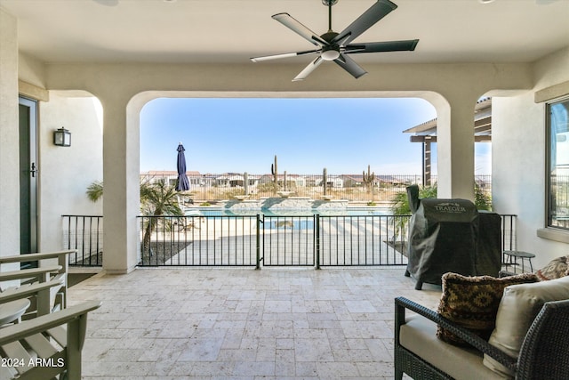 view of patio / terrace with ceiling fan and a community pool