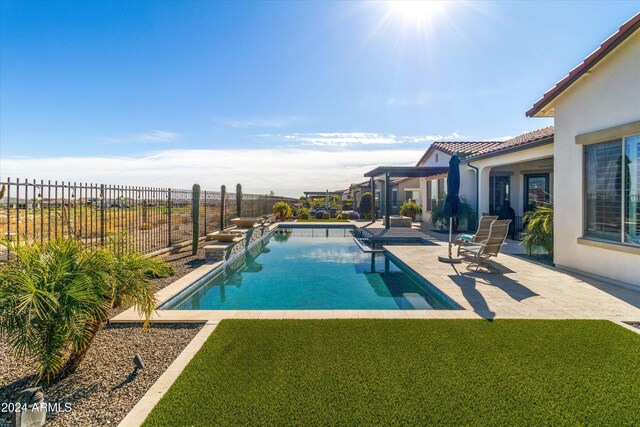 view of pool featuring a patio and a yard