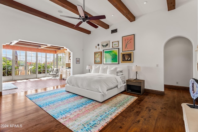 bedroom featuring beamed ceiling, ceiling fan, dark wood-type flooring, and access to outside