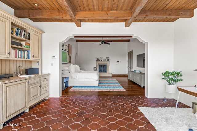 unfurnished bedroom featuring sink, beamed ceiling, and wooden ceiling