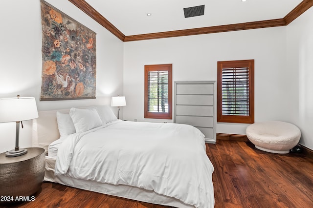 bedroom featuring crown molding and dark wood-type flooring