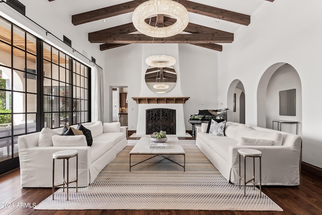 living room featuring a towering ceiling and dark hardwood / wood-style flooring