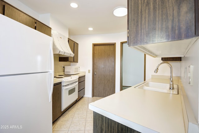 kitchen with sink, white appliances, light tile patterned floors, and ventilation hood