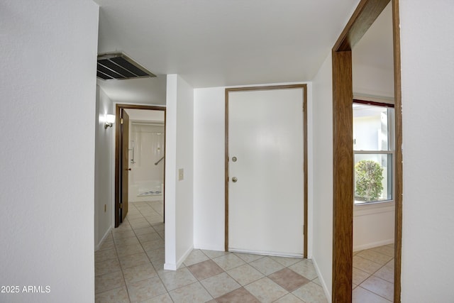 corridor featuring light tile patterned flooring