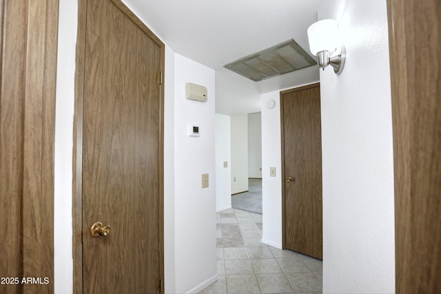 corridor featuring light tile patterned floors