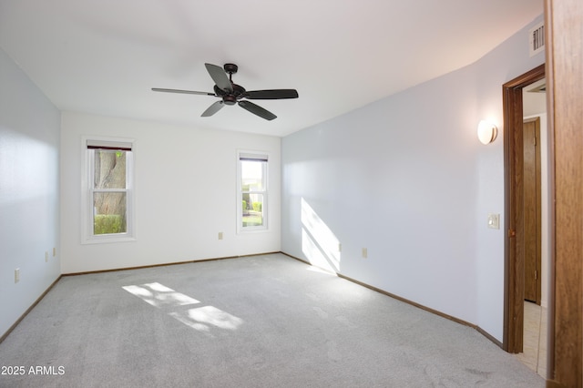 unfurnished room with ceiling fan and light carpet