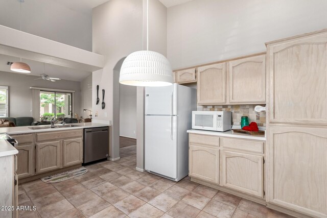 23756 S Vacation Way, Sun Lakes, AZ 85248 - kitchen with white appliances, light brown cabinets, a sink, a high ceiling, and light countertops