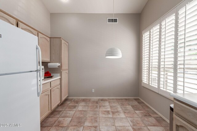 23756 S Vacation Way, Sun Lakes, AZ 85248 - kitchen with freestanding refrigerator, hanging light fixtures, light countertops, and light brown cabinetry