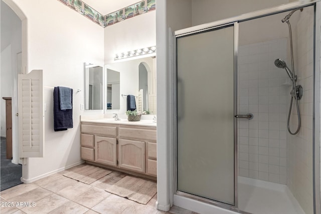 23756 S Vacation Way, Sun Lakes, AZ 85248 - bathroom with a stall shower, double vanity, tile patterned flooring, and baseboards