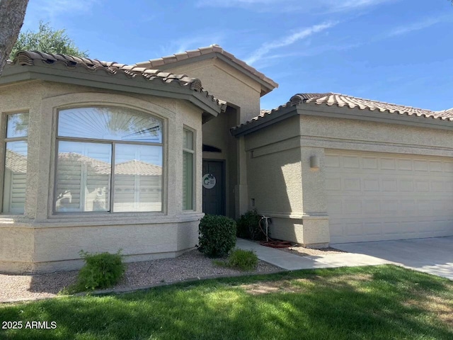 23756 S Vacation Way, Sun Lakes, AZ 85248 - view of front of property featuring a tile roof, an attached garage, concrete driveway, and stucco siding