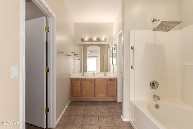 bathroom featuring tub / shower combination, vanity, and tile patterned flooring