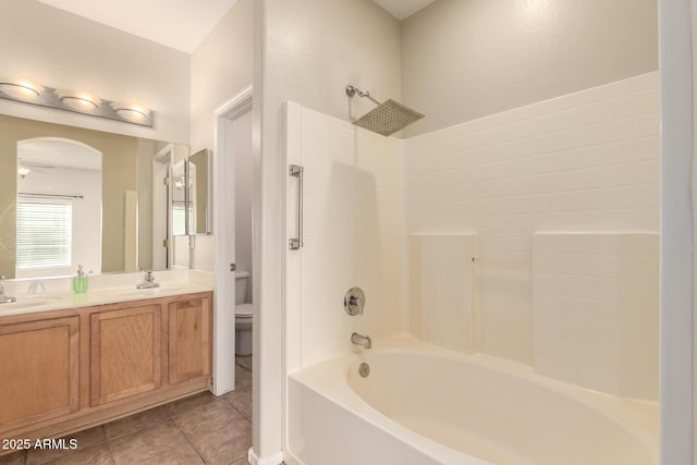 full bathroom featuring tub / shower combination, tile patterned floors, vanity, toilet, and ceiling fan