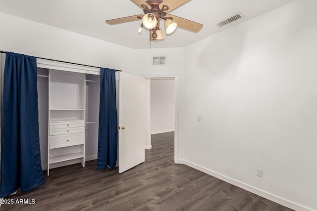 unfurnished bedroom with ceiling fan and dark hardwood / wood-style flooring