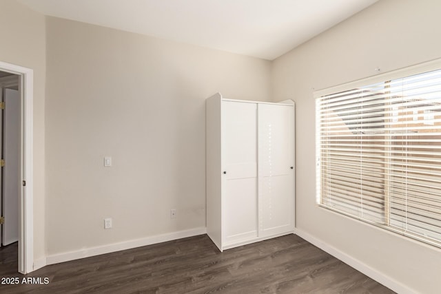 unfurnished bedroom featuring dark hardwood / wood-style floors