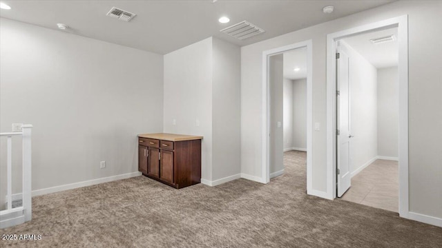 empty room with carpet flooring, visible vents, and recessed lighting