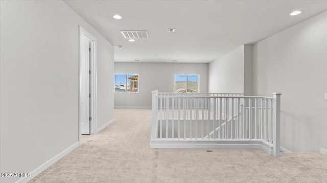 hallway featuring recessed lighting, carpet, visible vents, and baseboards