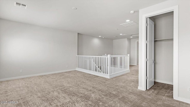 interior space with baseboards, visible vents, carpet, and recessed lighting