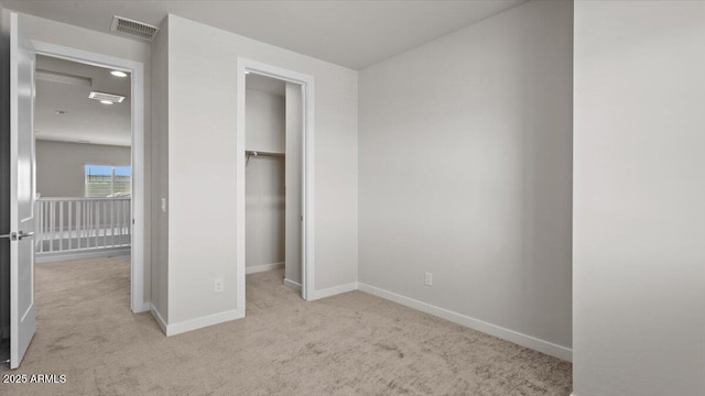 unfurnished bedroom featuring baseboards, visible vents, carpet, and a closet