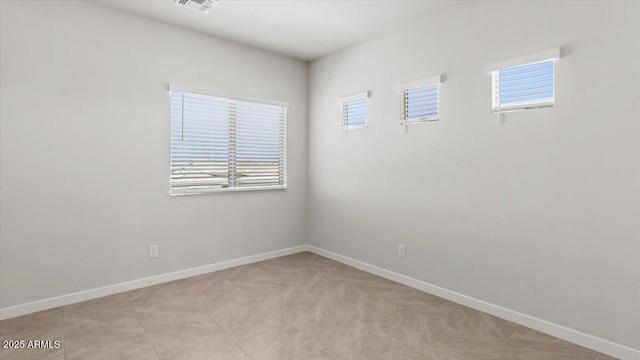 empty room featuring visible vents and baseboards