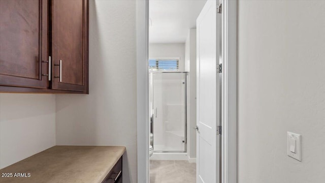 bathroom with vanity, toilet, tile patterned flooring, and a stall shower