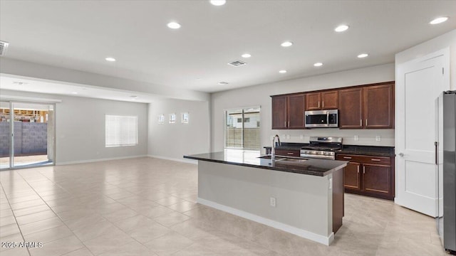 kitchen with a sink, visible vents, recessed lighting, appliances with stainless steel finishes, and light tile patterned floors