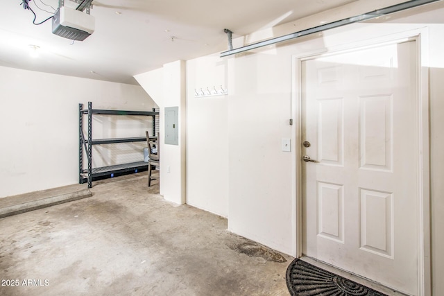 garage with a garage door opener and electric panel