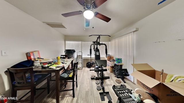 workout room featuring hardwood / wood-style floors and ceiling fan