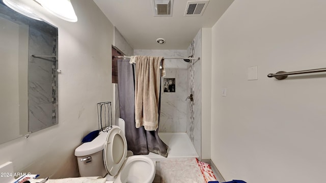 bathroom featuring toilet and walk in shower