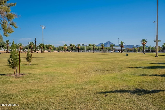 view of property's community with a lawn and a mountain view