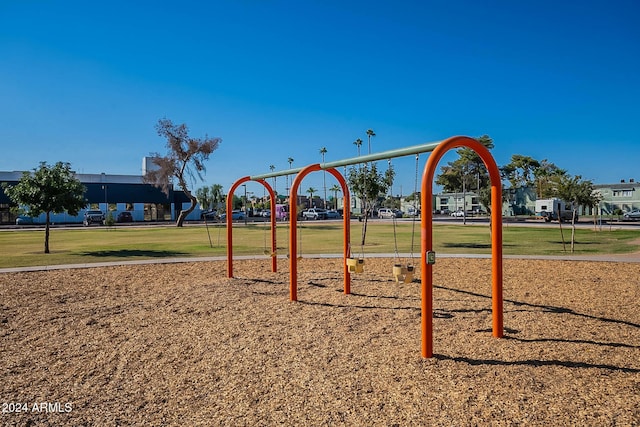 view of jungle gym featuring a lawn