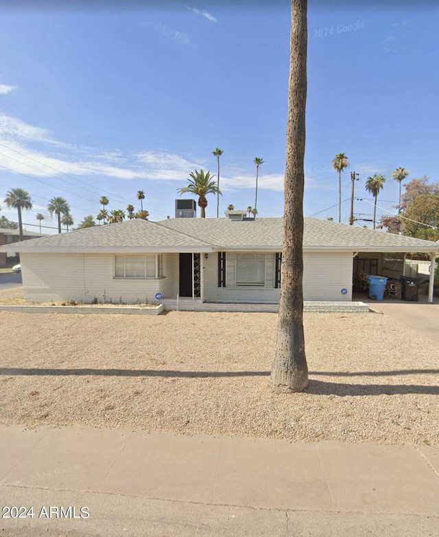 single story home featuring a carport