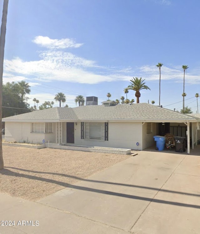 single story home featuring a carport