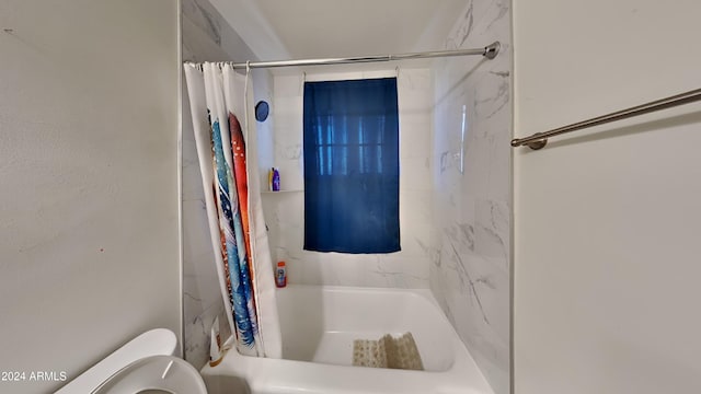 bathroom with shower / tub combo and toilet