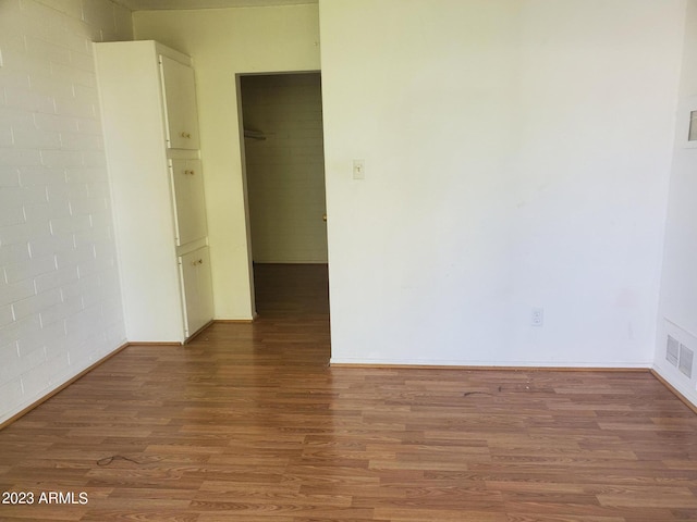 spare room with wood-type flooring