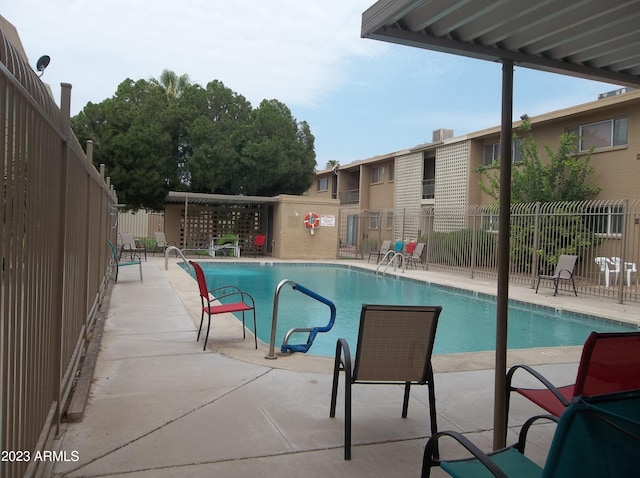 view of swimming pool with a patio area