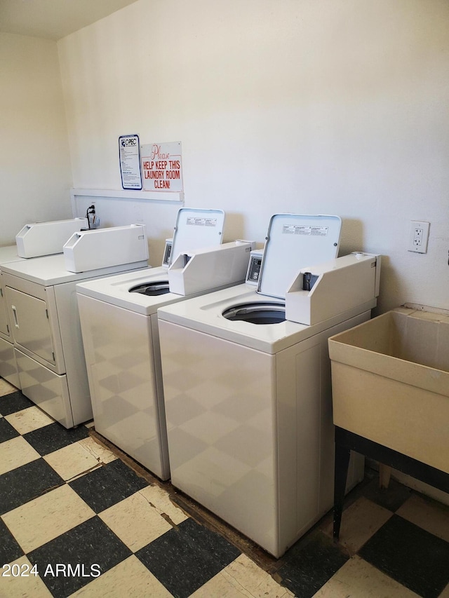 laundry room with washing machine and dryer and sink