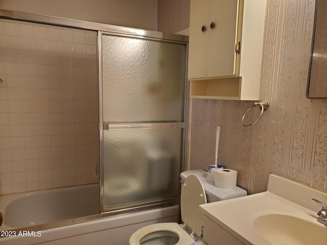 full bathroom featuring shower / bath combination with glass door, vanity, and toilet